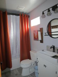 a bathroom with a toilet and a sink and a mirror at Private, Charming Cabin - Sleeps 5 - The Evergreen - Bryce Canyon National Park in Cannonville