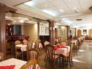 a dining room with tables and chairs in a restaurant at Business Club Selenča in Bač