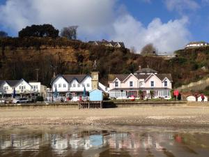 a group of houses on the shore of a beach at The Chestnuts in Shanklin