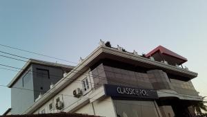 people sitting on the top of a building at Hotel Mudra Midtown Suites & Rooms in Kalasa