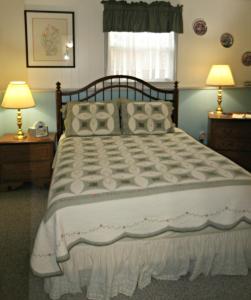 a bedroom with a large bed with pillows at Carriage Corner Bed & Breakfast in Gordonville
