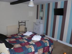 a bedroom with a bed with towels on it at Belle Vue Hotel in Llanwrtyd Wells