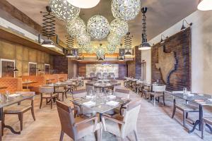 a restaurant with tables and chairs and chandeliers at Hideaway at Royalton Saint Lucia, An Autograph Collection All-Inclusive Resort, Adults Only in Gros Islet