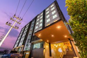 a tall building with a staircase in front of it at deVloft hotel Korat in Nakhon Ratchasima