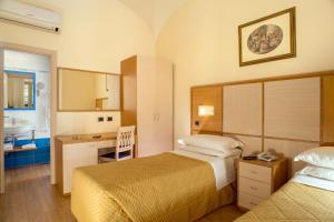 Posteľ alebo postele v izbe v ubytovaní Hotel Piemonte