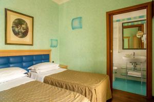 Posteľ alebo postele v izbe v ubytovaní Hotel Piemonte