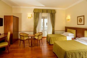 Posteľ alebo postele v izbe v ubytovaní Hotel Piemonte
