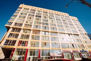 a tall building with many windows on a street at Большая Подгорная 57 in Tomsk