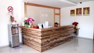 a woman sitting at a counter in a restaurant at Aloha Hotel in Lumut