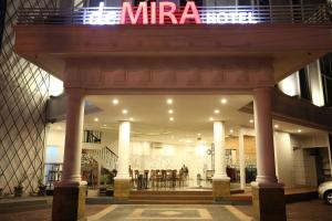 un frente de tienda con un cartel encima en DeMira Hotel, en Surabaya
