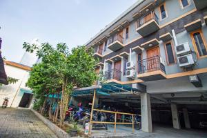 a building with a motorcycle parked in front of it at RedDoorz Plus near Ciputra World Kuningan 2 in Jakarta