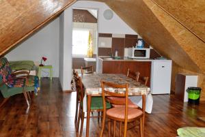 a kitchen and dining room with a table and chairs at Chaty Antónia in Hriňová