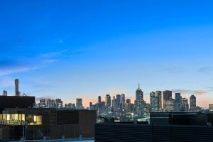 a view of a city skyline at dusk at District South Yarra in Melbourne