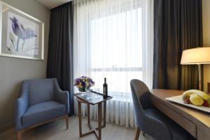 a room with a table and chairs and a window at Holiday Inn Bursa - City Centre by IHG in Bursa