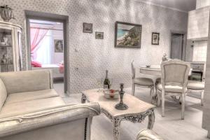 a living room with a couch and a table at Bebeto Suite in Corfu Town