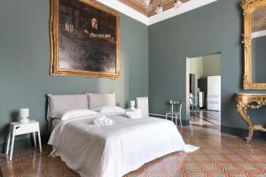 Ένα ή περισσότερα κρεβάτια σε δωμάτιο στο Duomo Housing Catania