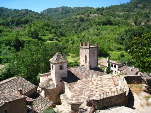 an aerial view of a village with a clock tower at Cal Vidal in Mura