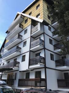 a white building with balconies on the side of it at Apartment Koko in Kopaonik