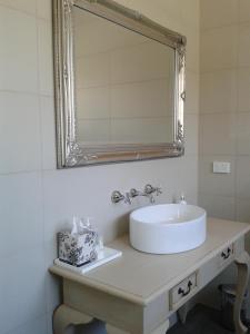 a bathroom with a sink and a mirror at Casa Rossa - Barossa in Lyndoch