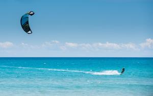 a man kite surfing in the ocean on the water at Keros Blue - Luxury in Wilderness in Kalliópi