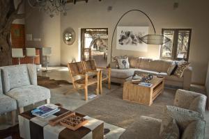 a living room filled with furniture and a couch at Moditlo River Lodge in Hoedspruit