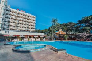 a large swimming pool in front of a hotel at Rex Hotel Vung Tau in Vung Tau