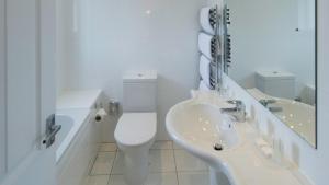 a bathroom with a sink, toilet and bathtub at The Park Hotel in Barnstaple