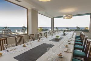 a long dining room with a long table with wine glasses at Hotel Meridiano in Termoli