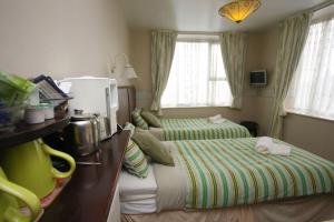 a small bedroom with two beds and a desk with at Boltonia in Blackpool