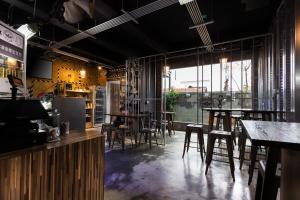 a restaurant with tables and chairs in a room at 和平公獄監獄文旅 近東大門夜市 Peace Prison Theme Inn in Hualien City