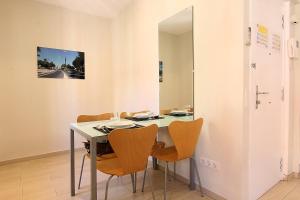 
a dining room table and chairs in a room at ClassBedroom Barcelona Beach Apartments in Barcelona
