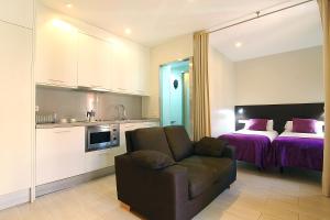 a living room with a couch and a bed at ClassBedroom Barcelona Beach Apartments in Barcelona