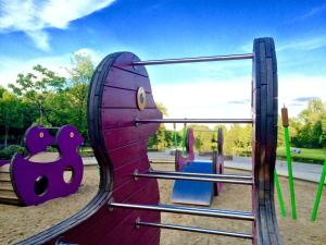a playground with a purple slide in a park at Haus Stallmeister in Lippstadt