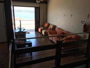 a living room with couches and a view of the ocean at Hostel Berghaus in Florianópolis