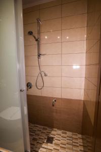 
a bathroom with a shower stall and a shower curtain at Hotel Marianna in Drama
