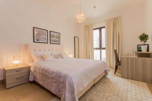 a bedroom with a large bed and a window at Near Burj Khalifa & Dubai Mall - Zanzabeel in Dubai