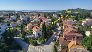 an aerial view of a town with houses and a yellow arrow at Apartments Villa Mattossi in Rovinj