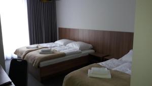 Postel nebo postele na pokoji v ubytování Hotel Garden