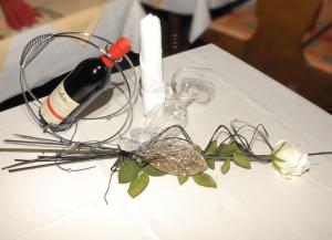 a bottle of wine and glasses on a table at Hotel Stadtschänke in Bad König