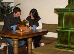 a man and a woman sitting at a table at Hotel Stadtschänke in Bad König