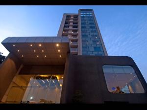 a tall building with glass windows in front of it at Keys Select by Lemon Tree Hotels, Visakhapatnam in Visakhapatnam