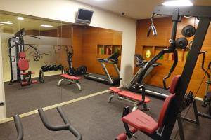 a gym with several tread machines and a mirror at Acevi Villarroel in Barcelona