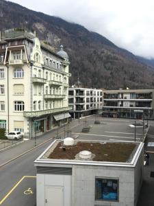 a view of a city with a building and a street at Swiss Holidays-City Apartments Interlaken in Interlaken