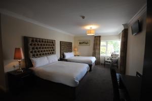 Un pat sau paturi într-o cameră la Castle Lodge