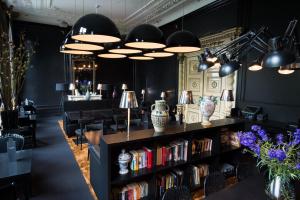 a room with a book shelf filled with books at Canal House in Amsterdam