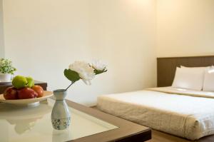 Good Ground Hotel Tainan tesisinde bir odada yatak veya yataklar