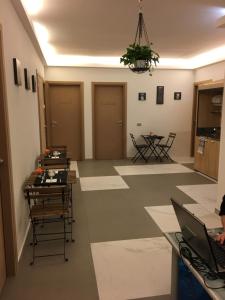 a room with two doors and a table with a laptop at B&B La Casa di Klida in Minerbio