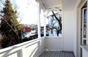 a porch with a white fence and a window at Haus Volksbank by Rujana in Binz
