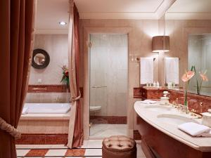 a bathroom with a tub and a sink and a shower at Grand Hotel Wien in Vienna