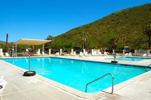 a large swimming pool with a mountain in the background at Pio Pico Camping Resort Cottage 1 in Jamul